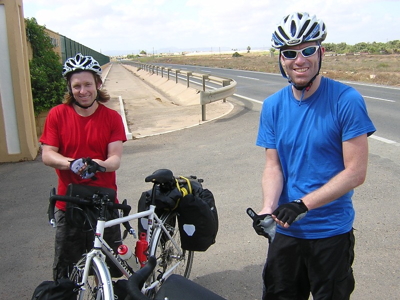 We&#39;ve all had a puncture - Ben´s had two - here are Ben and Sam, after happily taking care of a puncture on a highway outside Cartagena.